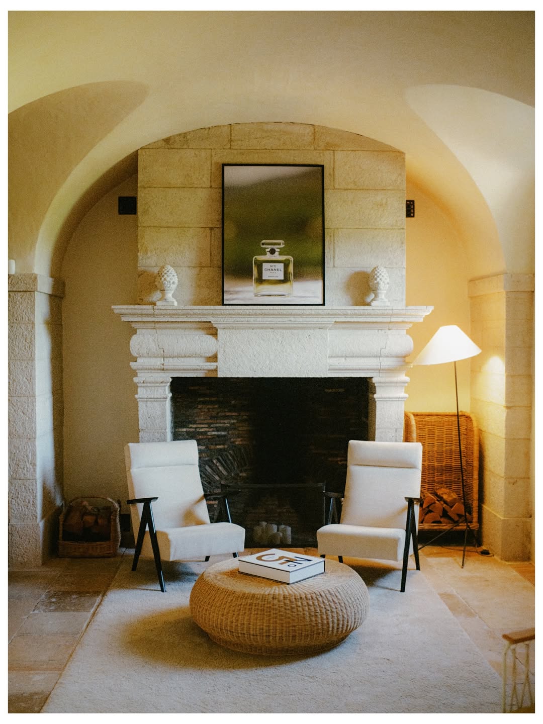 Sitting room with a stone fireplace under a vaulted ceiling
